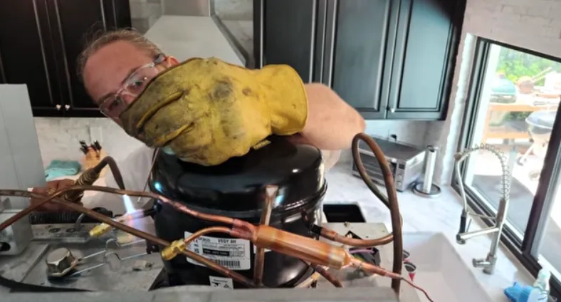 appliance repair technician diagnosing appliance